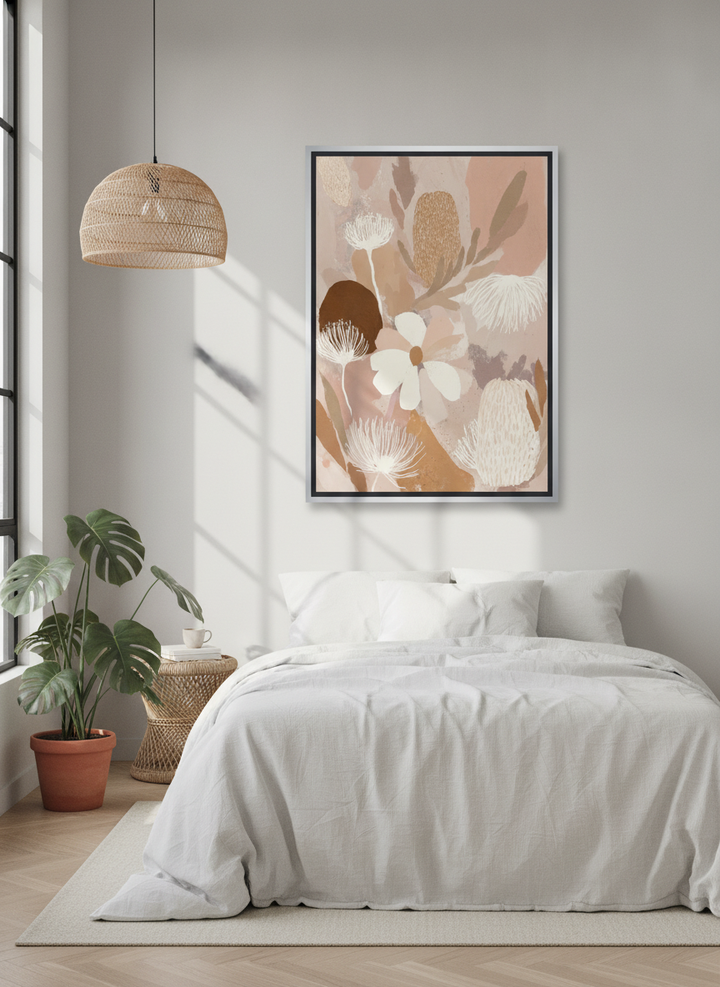 Canvas wall art with a silver leaf surround styled on the wall in a bright Scandinavian bedroom