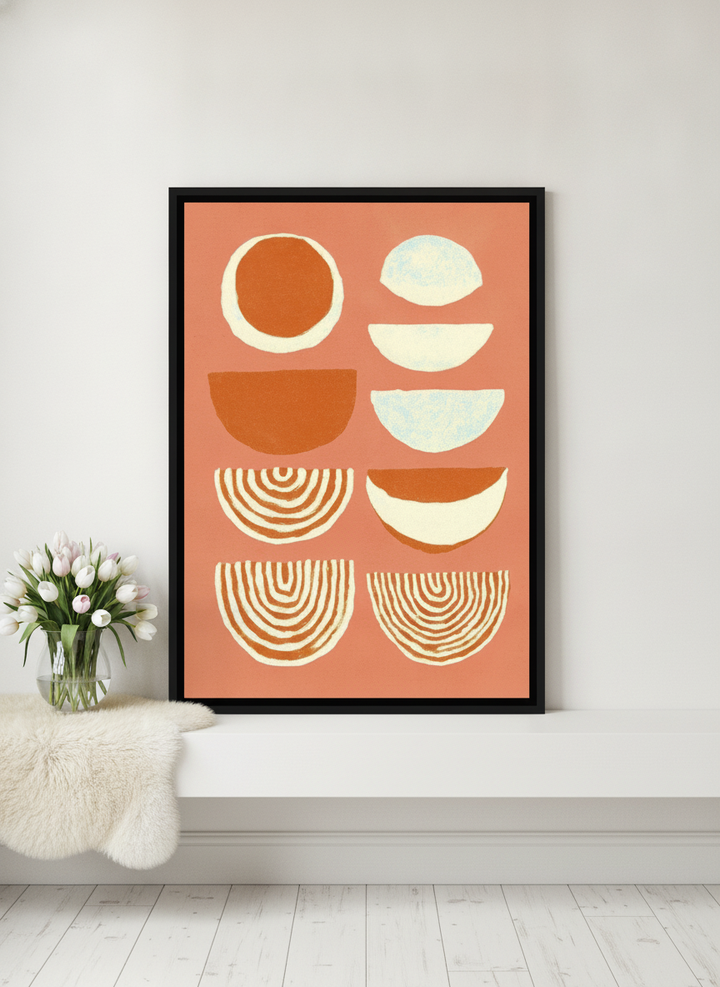 Canvas wall art with a black surround standing on a shelf in a bright Scandinavian home office