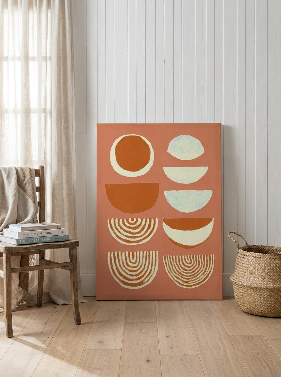 Stretched canvas wall art leaning against the wall in a coastal dining room