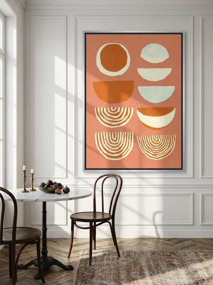 Oversized statement canvas wall art with a silver leaf surround styled on the wall in a Parisian dining room