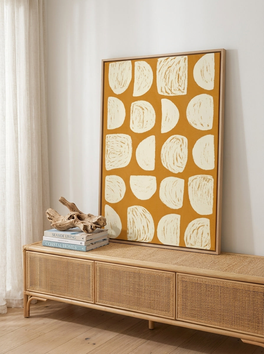 Canvas wall art with a natural timber surround standing on a sideboard in a coastal home office