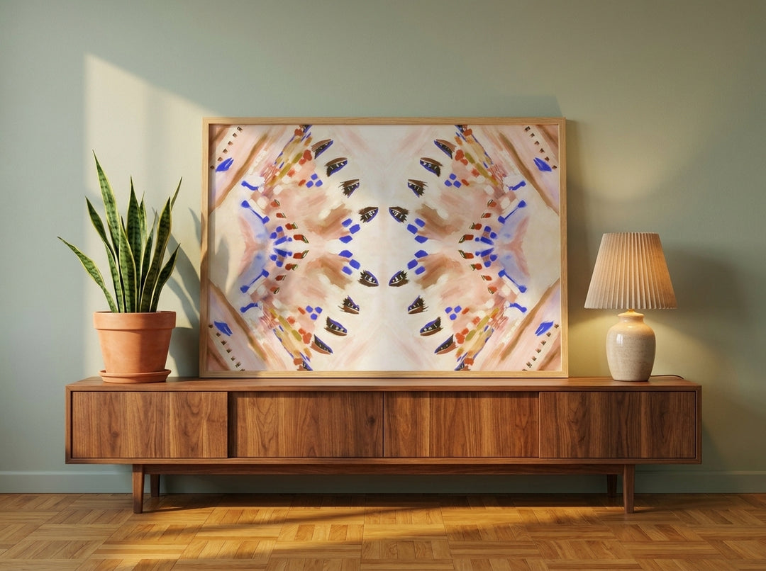 Modern wall art print standing on a sideboard in a mid-century home office