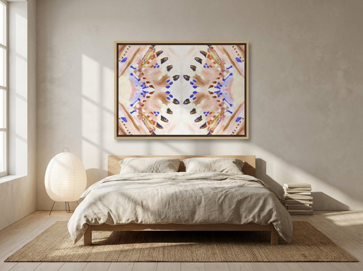 Canvas wall art with a natural timber surround styled on the wall in a warm Japandi bedroom