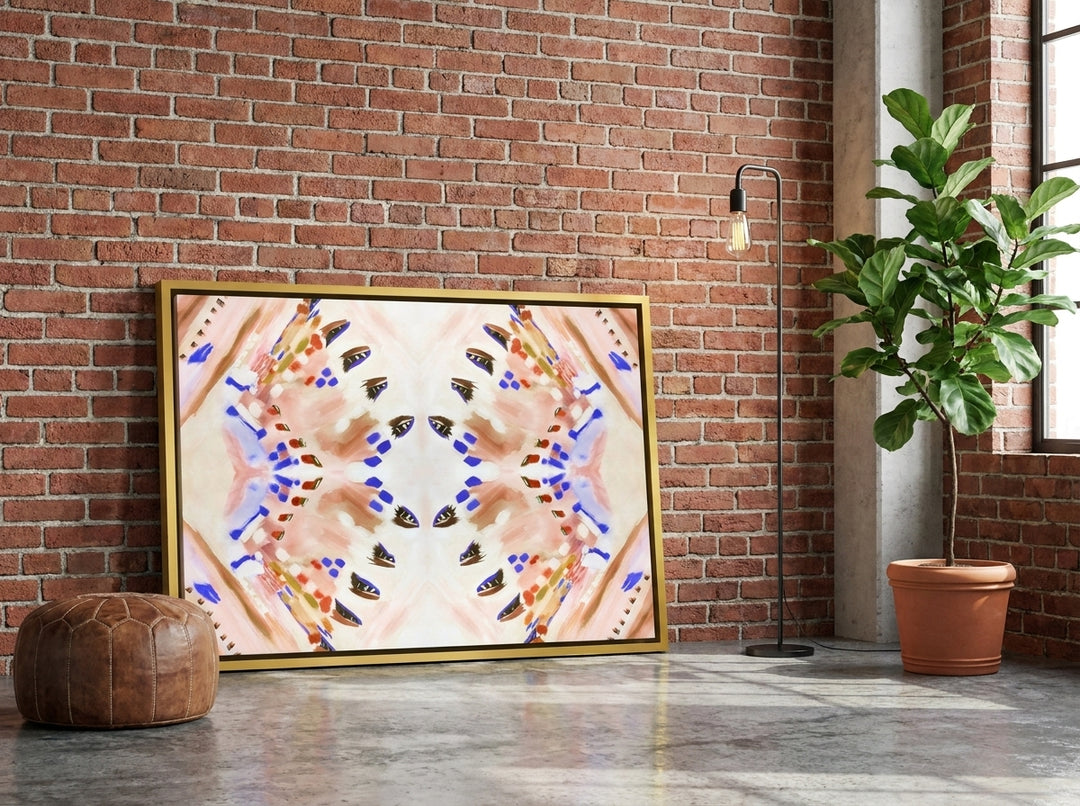Canvas wall art with a gold leaf surround leaning against the wall in an industrial loft living room