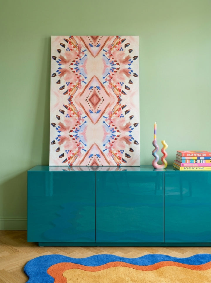 Stretched canvas wall art standing on a sideboard in a colourful eclectic dining room