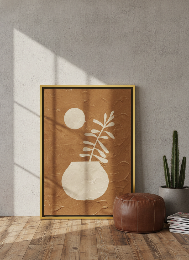 Canvas wall art with a gold leaf surround leaning against the wall in an industrial loft home office