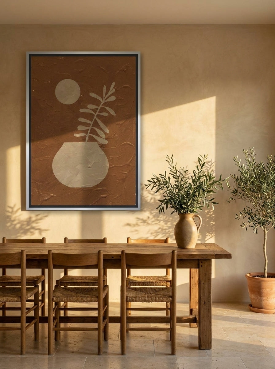 Oversized statement canvas wall art with a silver leaf surround styled on the wall in a Mediterranean dining room
