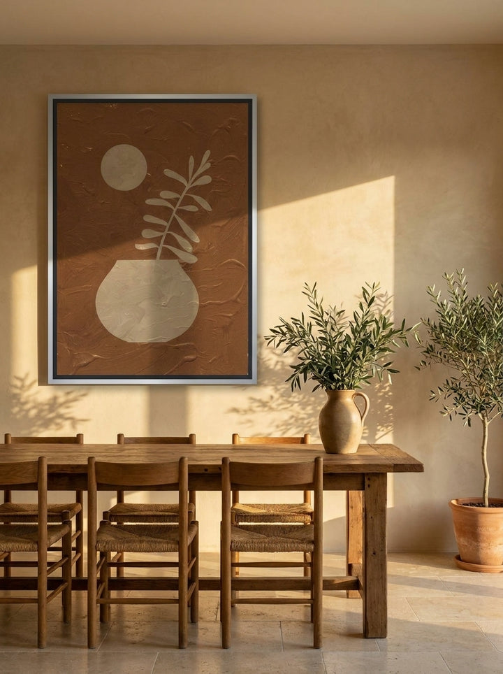 Oversized statement canvas wall art with a silver leaf surround styled on the wall in a Mediterranean dining room