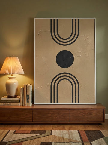 Modern wall art print standing on a sideboard in a mid-century home office