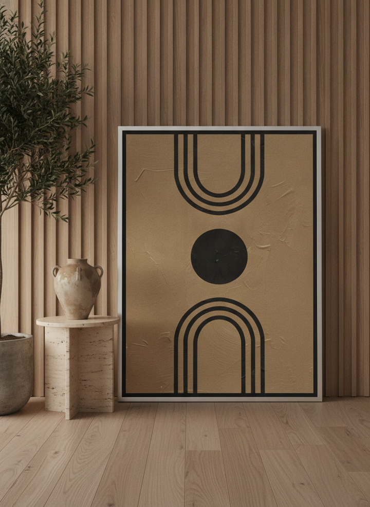 Oversized statement canvas wall art with a silver leaf surround leaning against the wall in a luxe bedroom