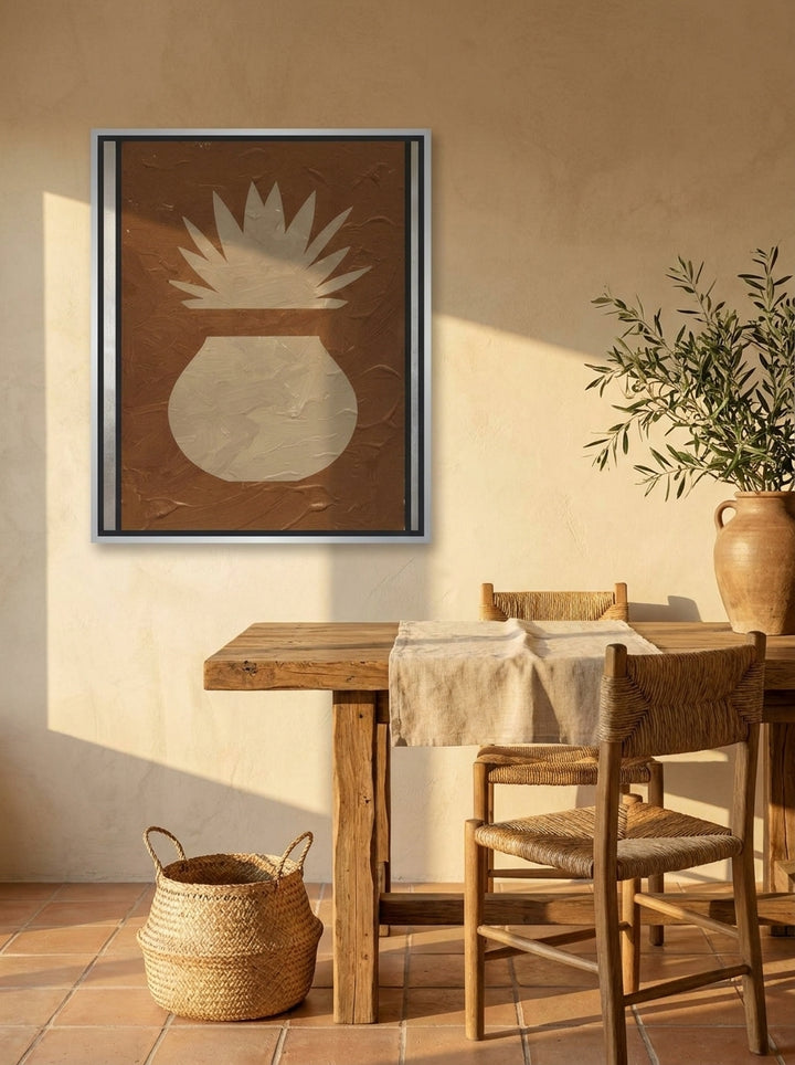 Canvas wall art with a silver leaf surround styled on the wall in a Mediterranean home office