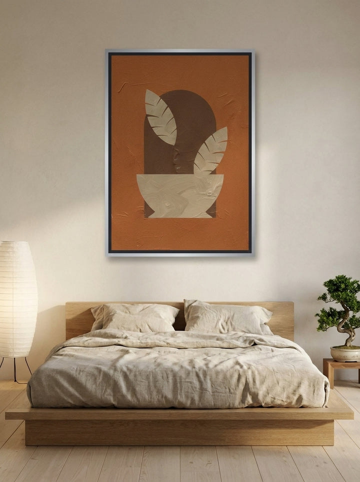 Canvas wall art with a silver leaf surround styled on the wall in a warm Japandi bedroom