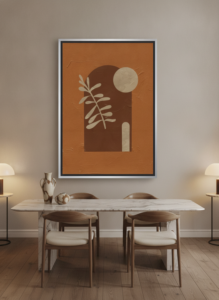 Oversized statement canvas wall art with a silver leaf surround styled on the wall in a luxe dining room