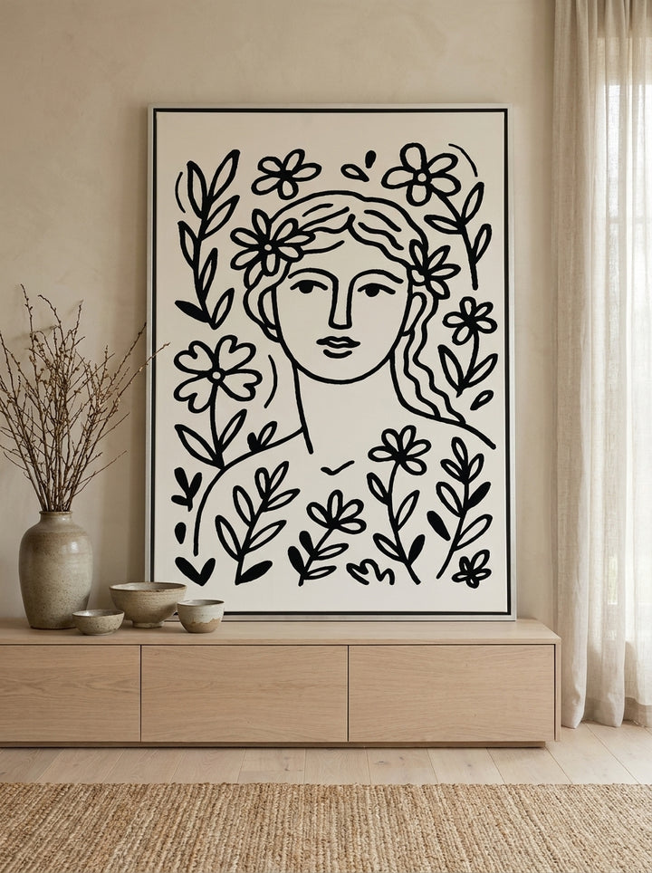 Canvas wall art with a silver leaf surround standing on a sideboard in a warm Japandi nursery
