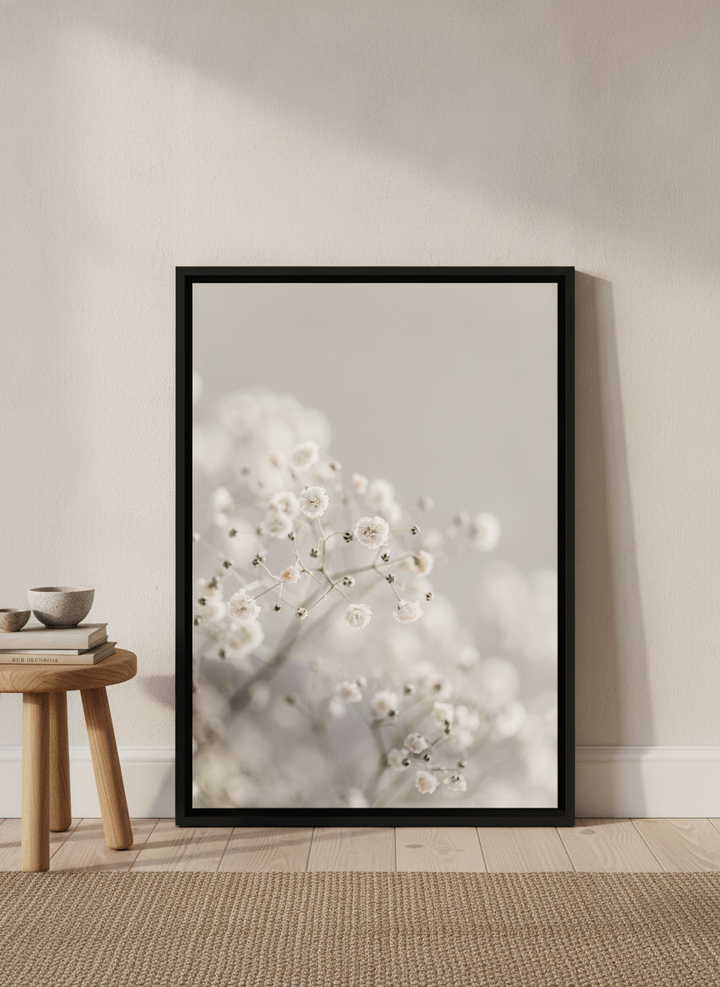 Canvas wall art with a black surround leaning against the wall in a warm Japandi nursery