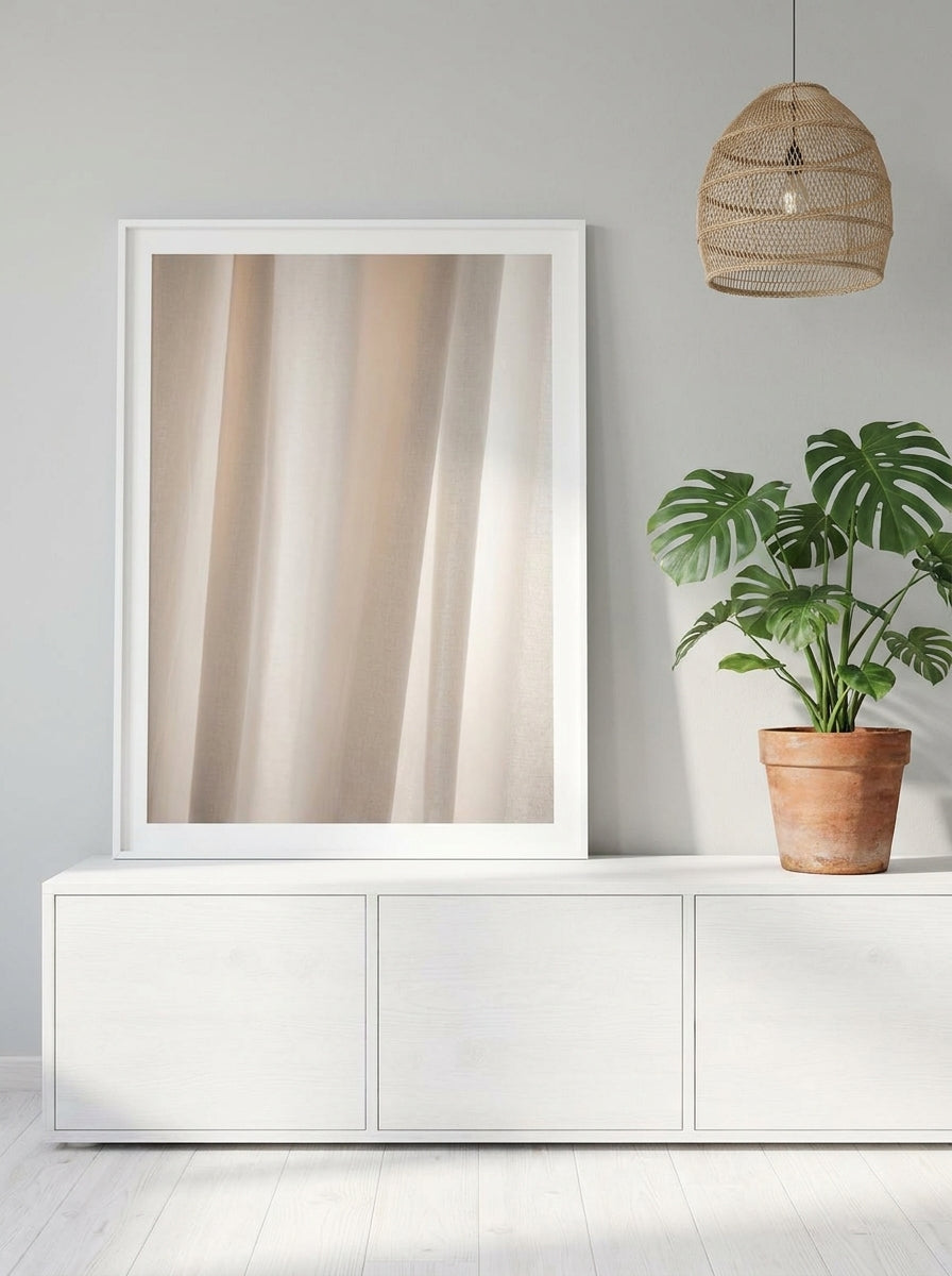 Modern wall art print standing on a sideboard in a bright Scandinavian bathroom