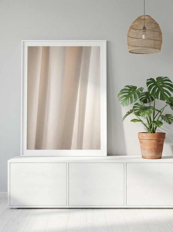 Modern wall art print standing on a sideboard in a bright Scandinavian bathroom
