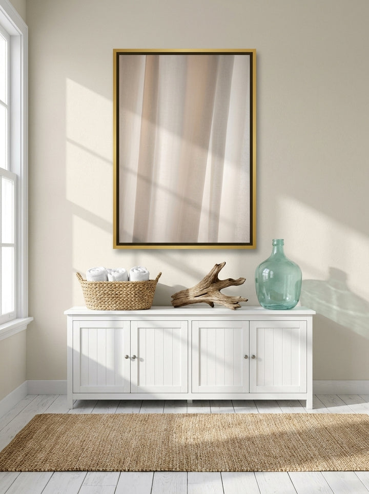 Canvas wall art with a gold leaf surround styled on the wall in a coastal bathroom
