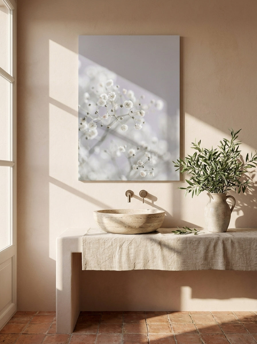 Stretched canvas wall art styled on the wall in a Mediterranean bathroom