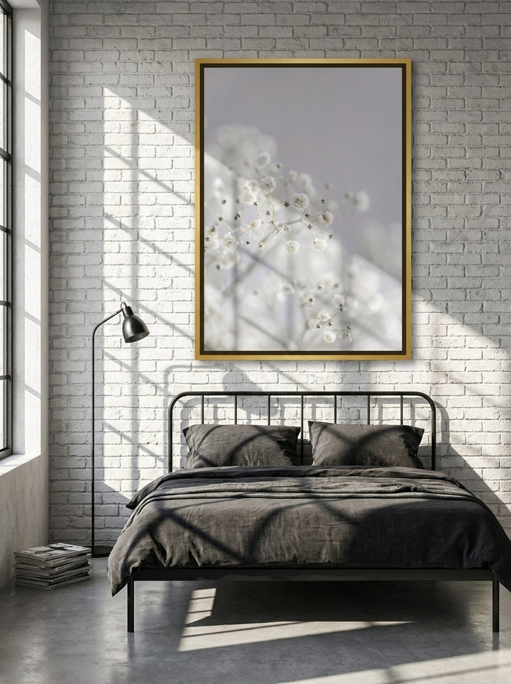 Canvas wall art with a gold leaf surround styled on the wall in an industrial loft bedroom
