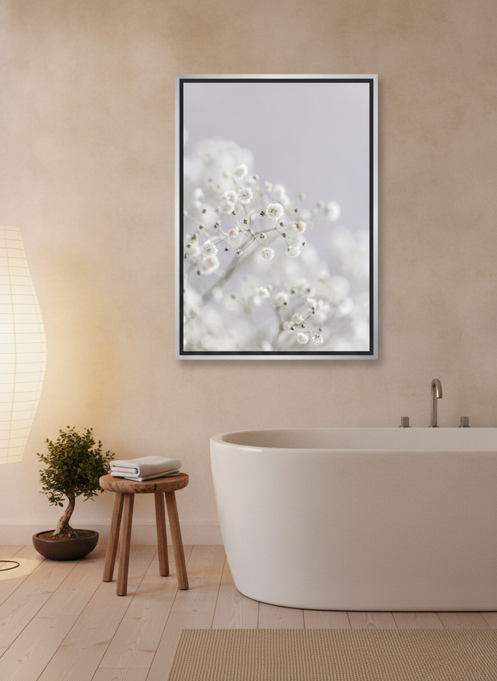 Canvas wall art with a silver leaf surround styled on the wall in a warm Japandi bathroom