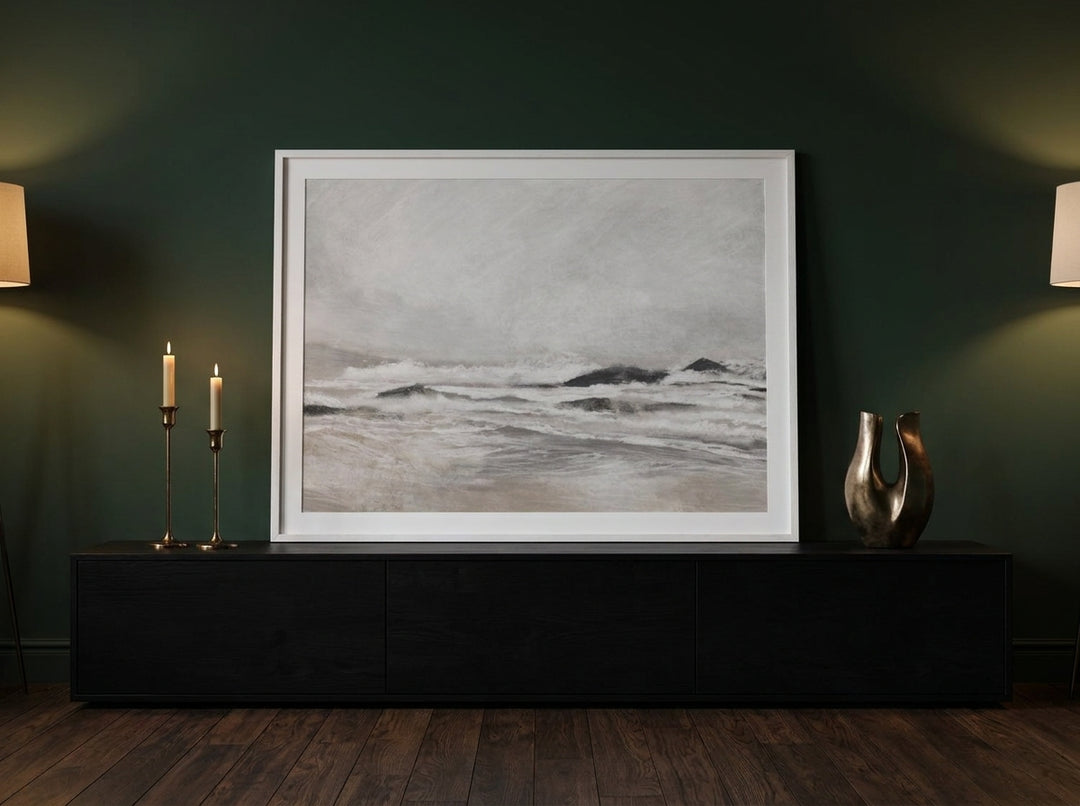 Modern wall art print standing on a console in a moody living room
