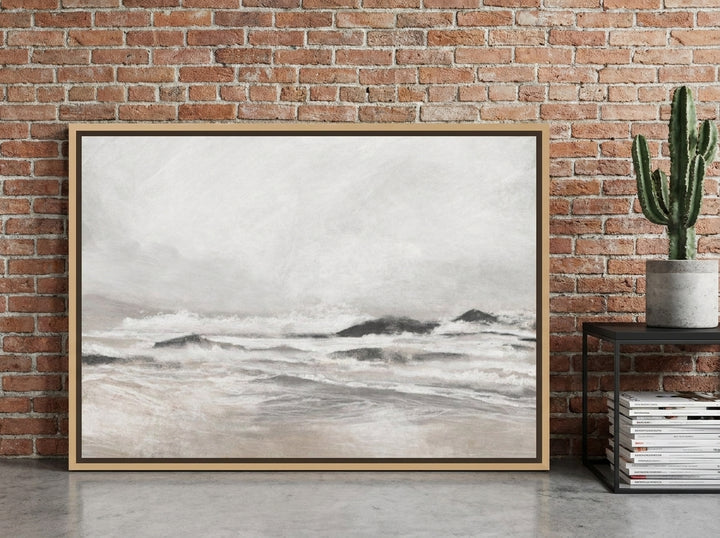 Oversized statement canvas wall art with a natural timber surround leaning against the wall in an industrial loft home office