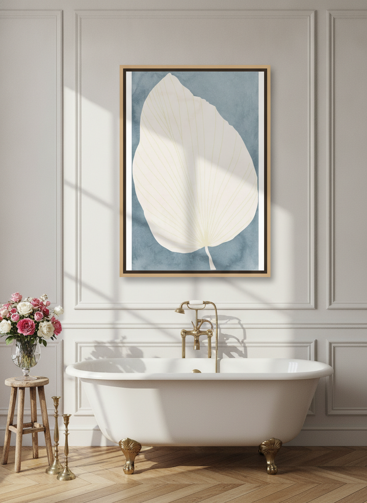 Canvas wall art with a natural timber surround styled on the wall in a Parisian bathroom