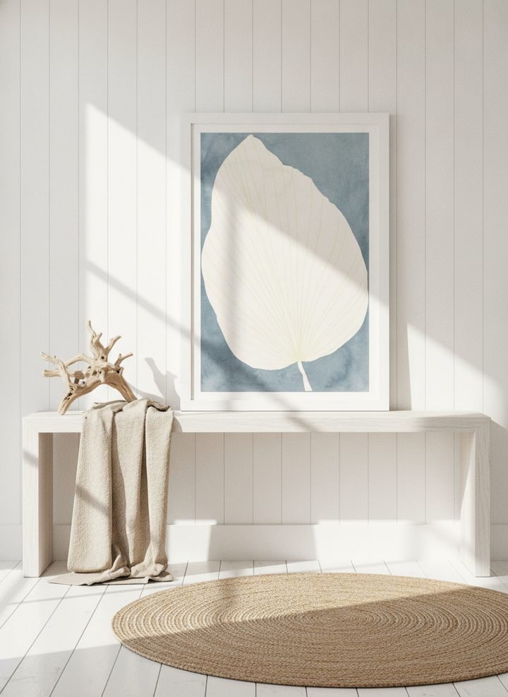 Modern wall art print standing on a console in a coastal bathroom