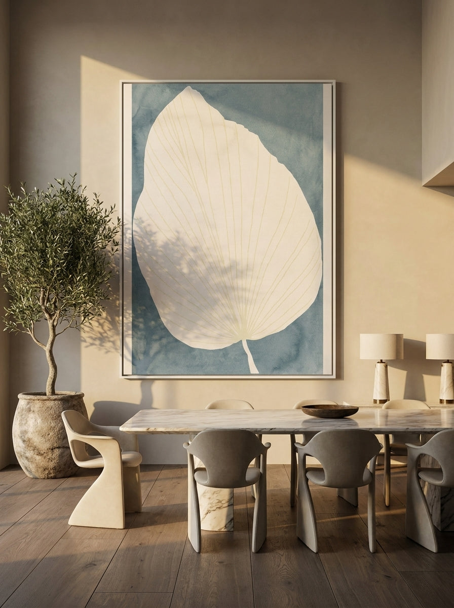 Oversized statement canvas wall art with a white surround styled on the wall in a luxe dining room