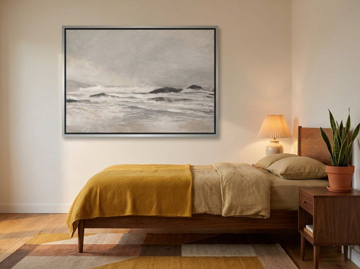 Canvas wall art with a silver leaf surround styled on the wall in a mid-century bedroom