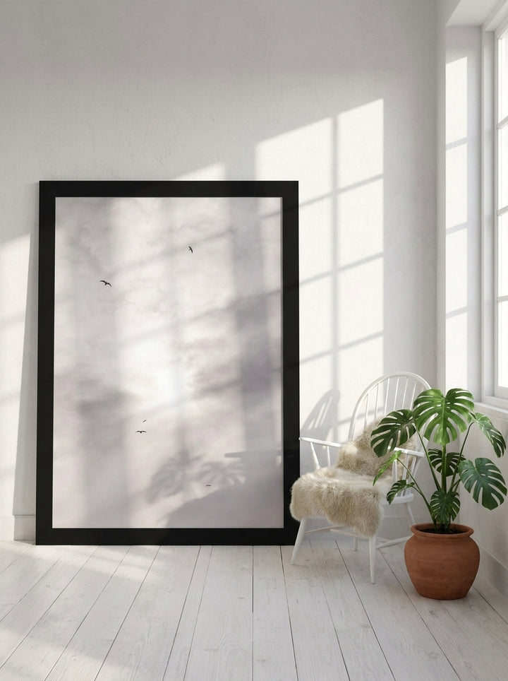 Oversized statement modern wall art print leaning against the wall in a bright Scandinavian living room