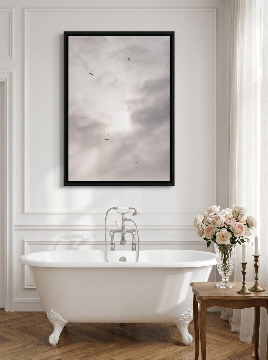 Canvas wall art with a black surround styled on the wall in a Parisian bathroom