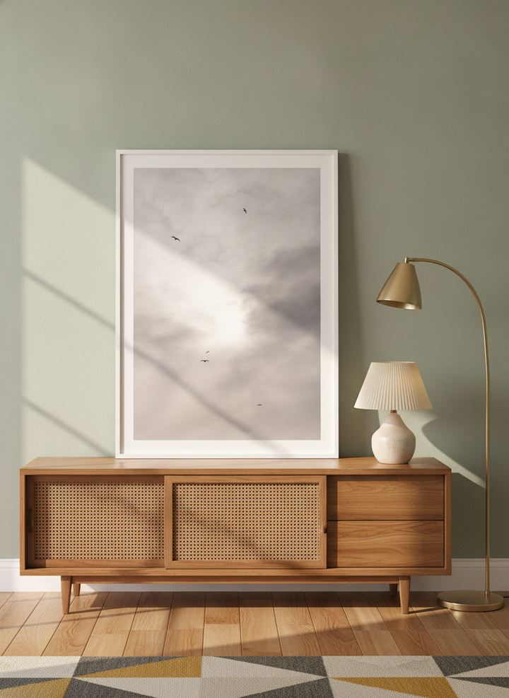 Modern wall art print standing on a sideboard in a mid-century bedroom