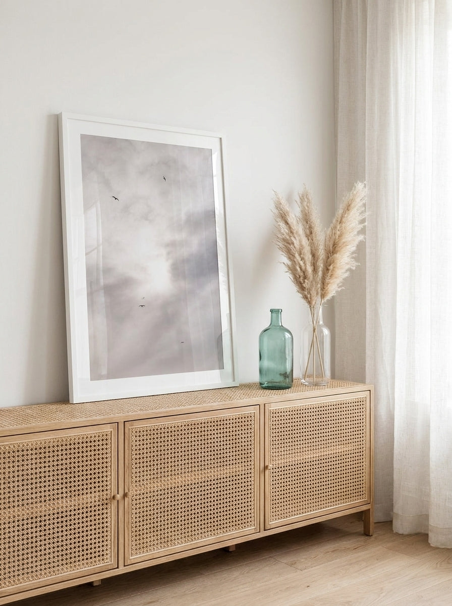Modern wall art print standing on a sideboard in a coastal home office