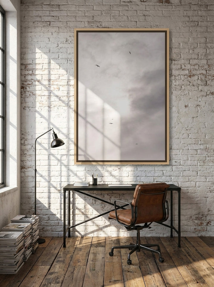 Canvas wall art with a natural timber surround styled on the wall in an industrial loft home office