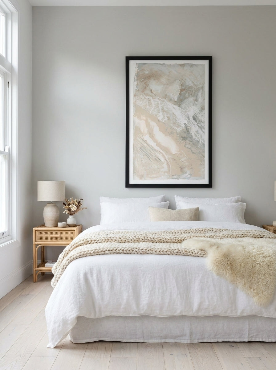 Oversized statement modern wall art print styled on the wall in a bright Scandinavian bedroom