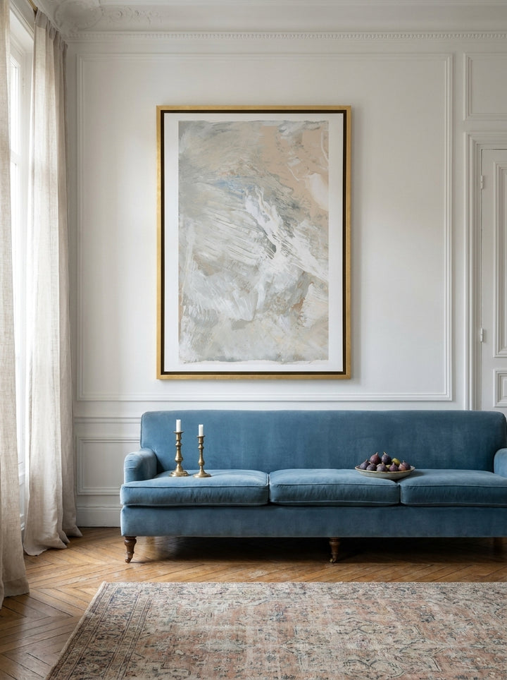 Oversized statement canvas wall art with a gold leaf surround styled on the wall in a Parisian living room
