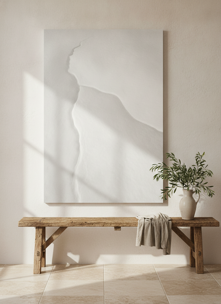 Stretched canvas wall art standing on a bench in a Mediterranean living room