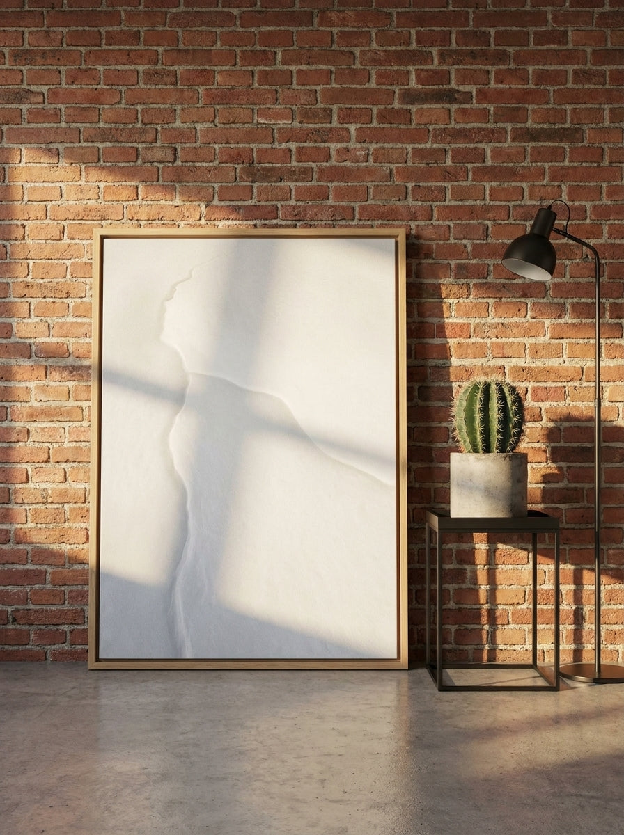 Canvas wall art with a natural timber surround leaning against the wall in an industrial loft home office