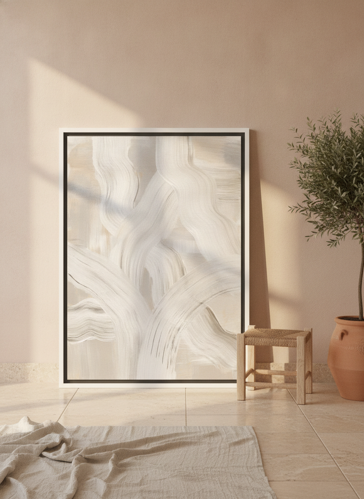 Canvas wall art with a white surround leaning against the wall in a Mediterranean bedroom