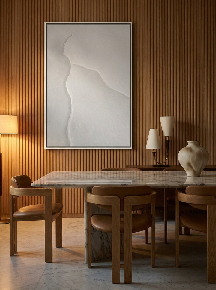 Oversized statement canvas wall art with a white surround styled on the wall in a luxe dining room