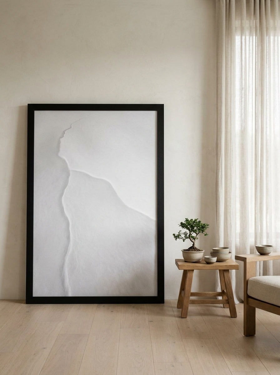 Oversized statement modern wall art print leaning against the wall in a warm Japandi living room