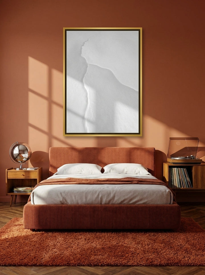 Canvas wall art with a gold leaf surround styled on the wall in a retro 70s bedroom
