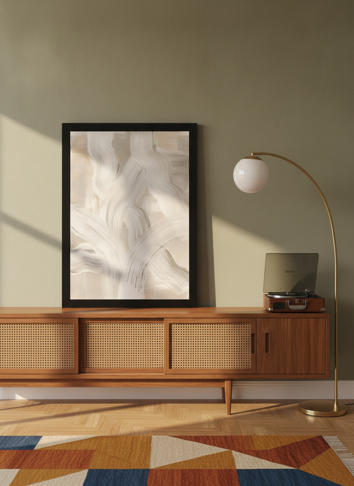 Modern wall art print standing on a sideboard in a mid-century living room