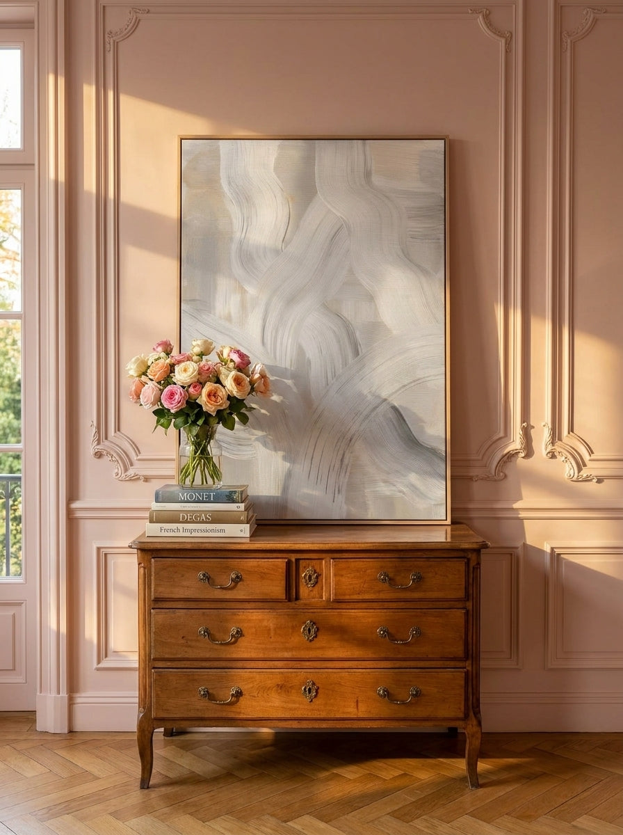 Stretched canvas wall art standing on a sideboard in a Parisian home office