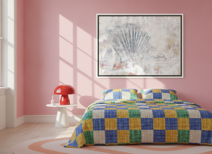 Canvas wall art with a white surround styled on the wall in a colourful eclectic bedroom