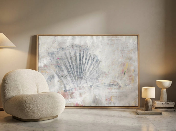Oversized statement canvas wall art with a natural timber surround leaning against the wall in a luxe living room