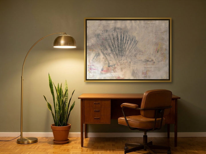 Canvas wall art with a gold leaf surround styled on the wall in a mid-century home office