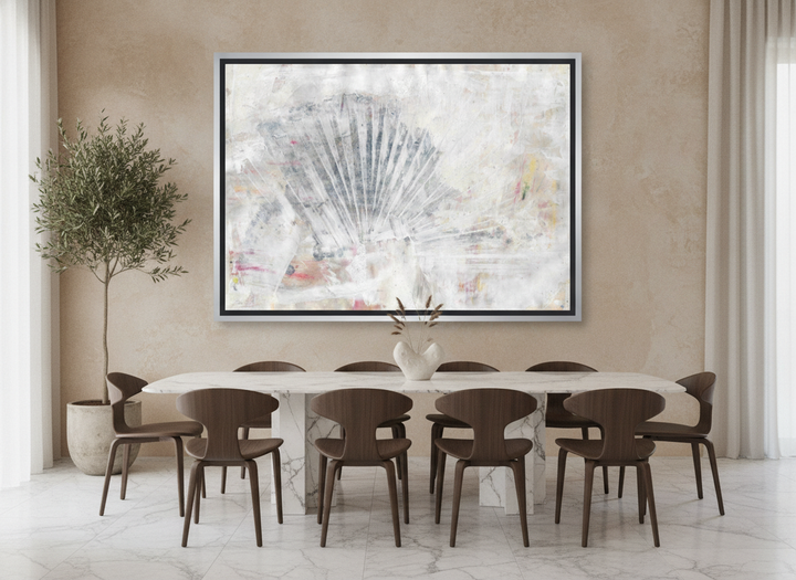 Oversized statement canvas wall art with a silver leaf surround styled on the wall in a luxe dining room